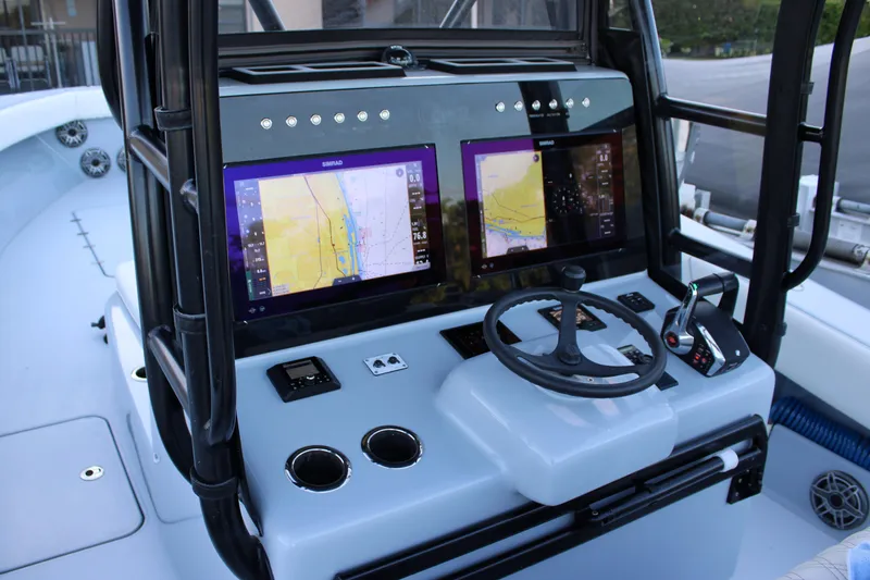 Slide: The Image of Cockpit of 2019 Conch 33 boat with dual navigation screens and steering wheel. - 5