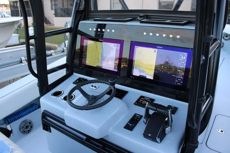 Slide: The Image of 2019 Conch 33 boat dashboard with dual Simrad navigation screens and steering wheel. - 6