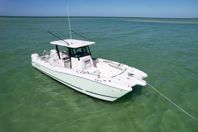 Slide: The Image of 2023 World Cat 325 CC boat anchored in clear turquoise water. - 10