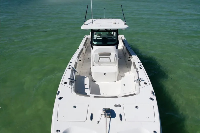 Slide: The Image of 2023 World Cat 325 CC boat on clear green water, aerial view. - 14