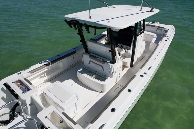 Slide: The Image of 2023 World Cat 325 CC boat on clear water, showcasing spacious deck and seating. - 17