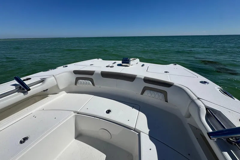 Slide: The Image of 2023 World Cat 325 CC boat on open water, showcasing spacious deck and seating. - 20