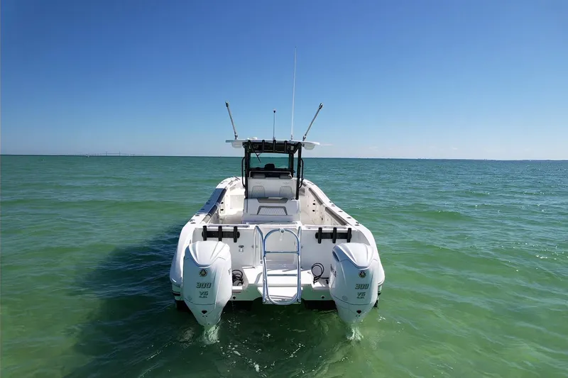 Slide: The Image of 2023 World Cat 325 CC boat on open sea, clear blue sky. - 3