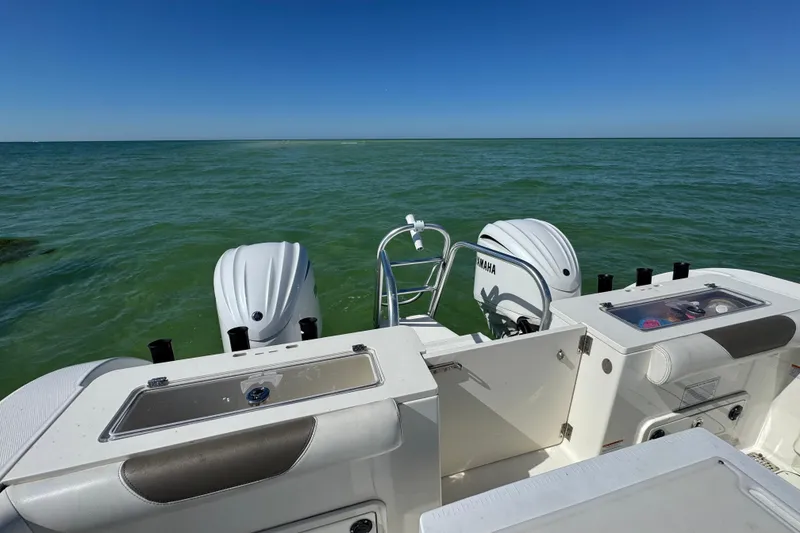 Slide: The Image of 2023 World Cat 325 CC boat with dual Yamaha engines on open water. - 30