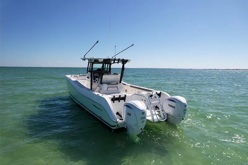 Slide: The Image of 2023 World Cat 325 CC boat with twin Yamaha engines on clear ocean water. - 4