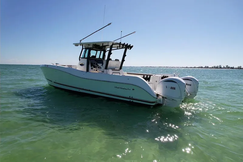 Slide: The Image of 2023 World Cat 325 CC boat on clear blue water under sunny sky. - 5