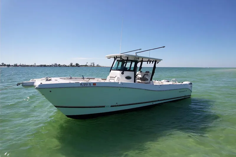 Slide: The Image of 2023 World Cat 325 CC boat on clear turquoise water under blue sky. - 6