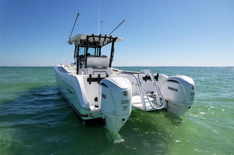 Slide: The Image of 2023 World Cat 325 CC boat with Yamaha engines on clear ocean water. - 9