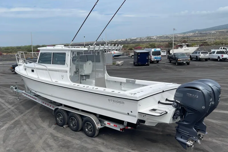 Slide: The Image of 2026 Steiger Craft 31 Fisherman boat on trailer, featuring dual Yamaha engines. - 10