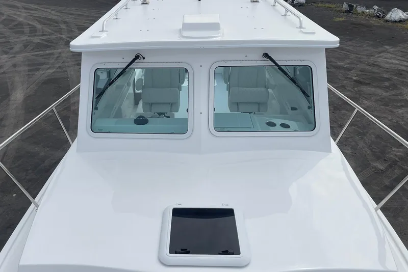 Slide: The Image of 2026 Steiger Craft 31 Fisherman boat, front view with windshield and deck details. - 13
