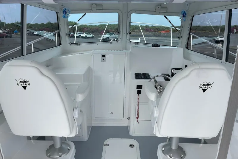 Slide: The Image of 2026 Steiger Craft 31 Fisherman boat interior with steering wheel and seating. - 14