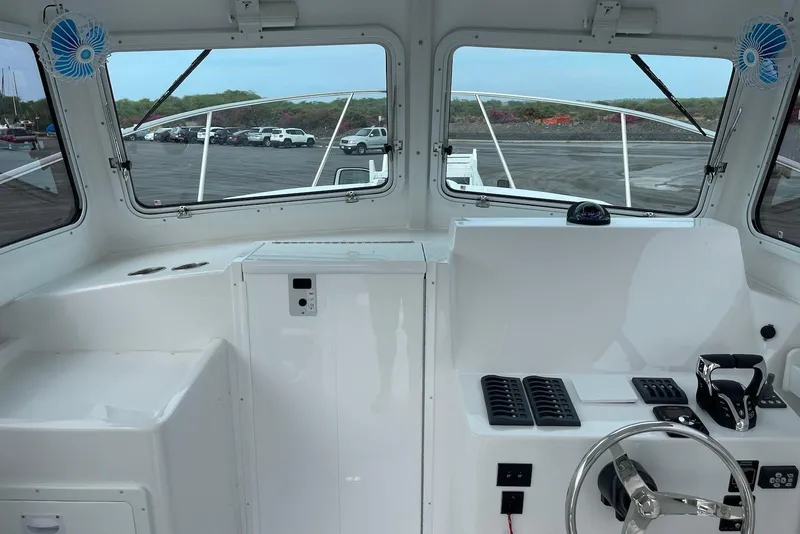 Slide: The Image of 2026 Steiger Craft 31 Fisherman boat interior with steering wheel and dashboard controls. - 15
