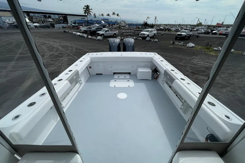 Slide: The Image of 2026 Steiger Craft 31 Fisherman boat deck with storage and seating, parked in a marina. - 17