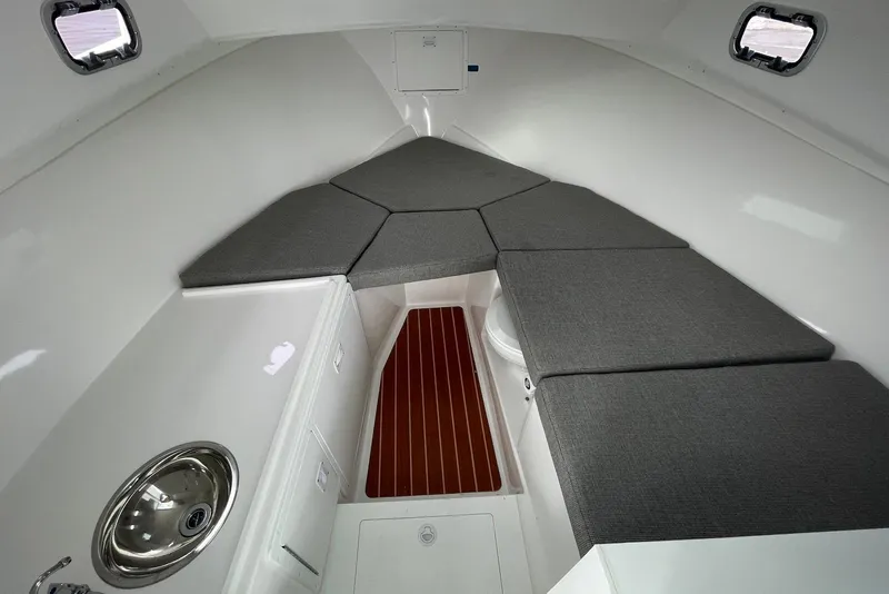 Slide: The Image of 2026 Steiger Craft 31 Fisherman cabin interior with cushions and sink. - 18