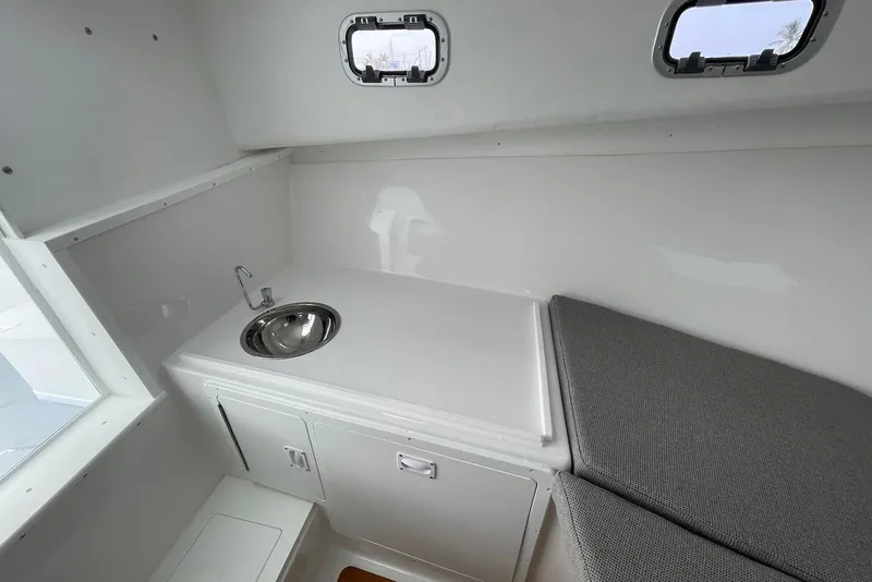Slide: The Image of 2026 Steiger Craft 31 Fisherman cabin interior with sink and seating area. - 19