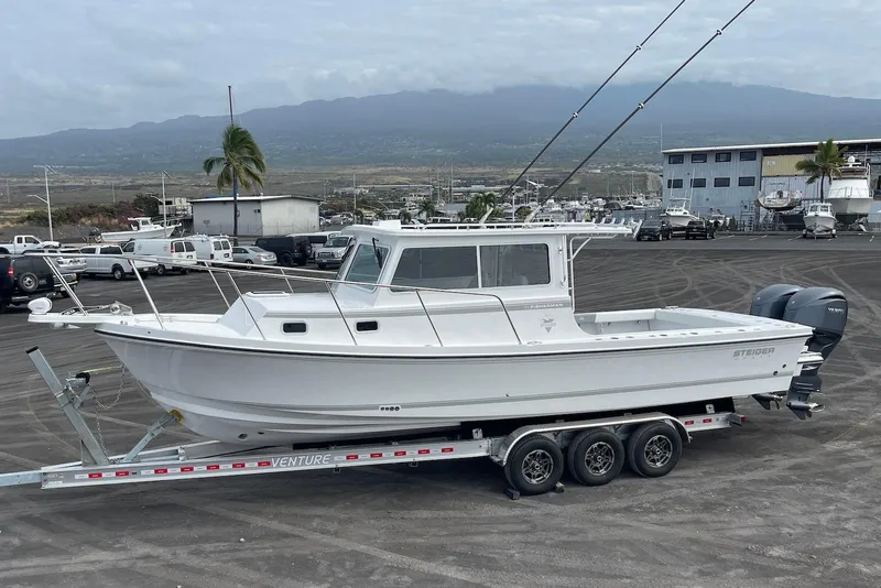 The Image of 2026 Steiger Craft 31 Fisherman boat on trailer in marina setting. - 2
