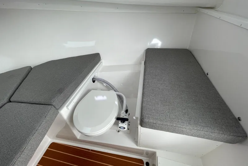 Slide: The Image of 2026 Steiger Craft 31 Fisherman cabin interior with seating and marine toilet. - 20