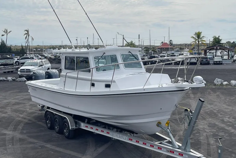 Slide: The Image of 2026 Steiger Craft 31 Fisherman boat on trailer in parking lot. - 5