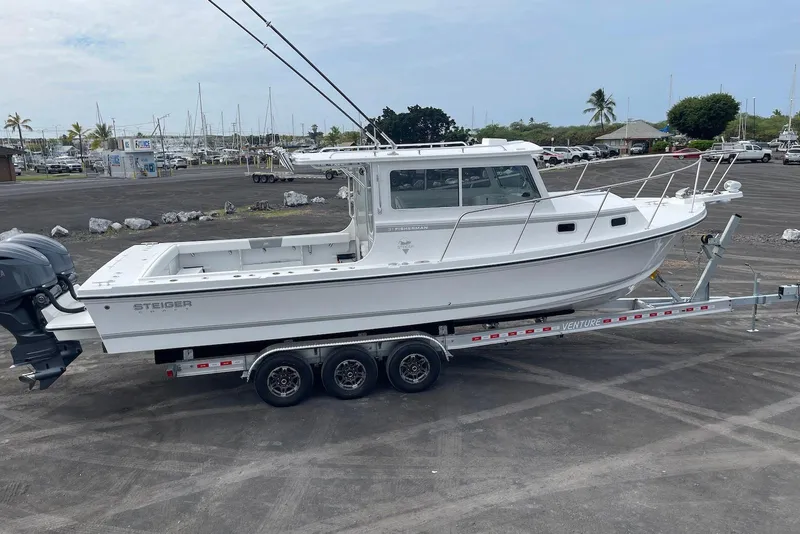 Slide: The Image of 2026 Steiger Craft 31 Fisherman boat on trailer in marina parking lot. - 7