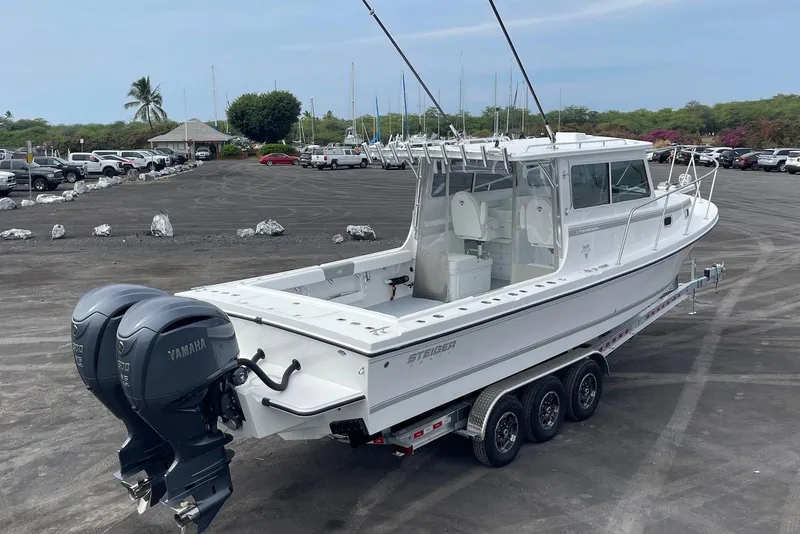 Slide: The Image of 2026 Steiger Craft 31 Fisherman boat with dual Yamaha engines on a trailer. - 8