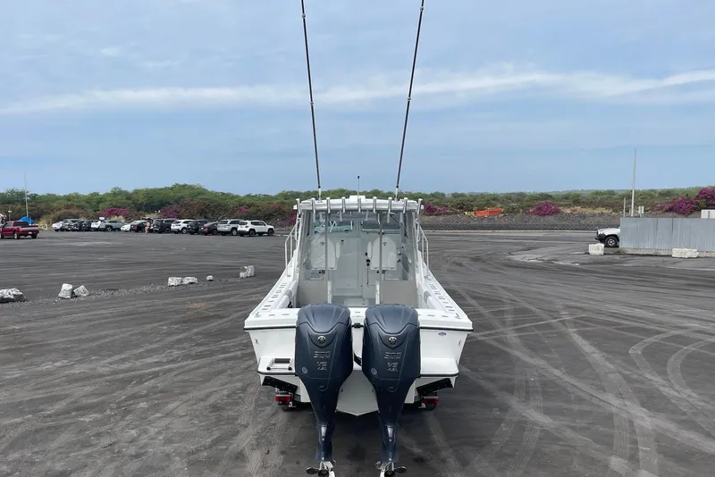 Slide: The Image of 2026 Steiger Craft 31 Fisherman boat with dual outboard motors in a parking lot. - 9