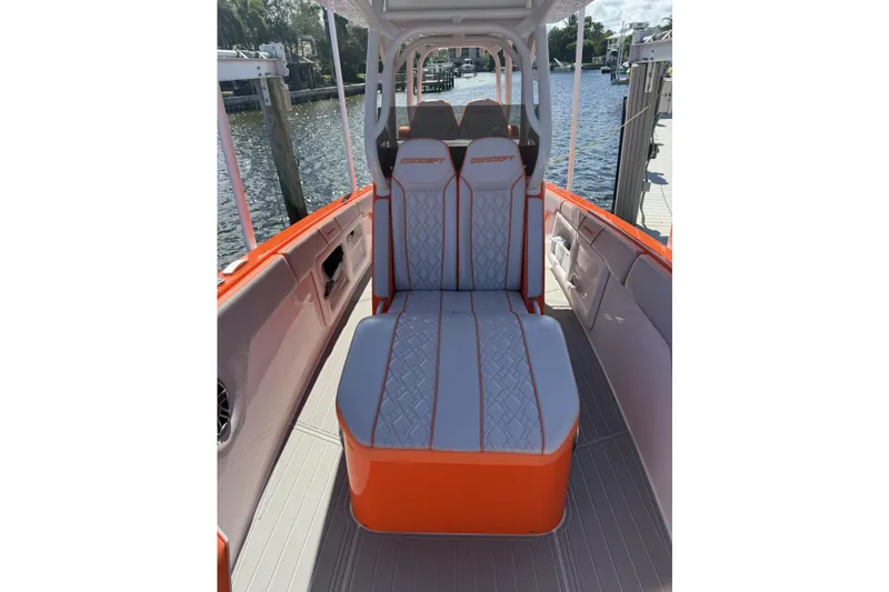 Slide: The Image of 2025 Concept 32' CC boat interior with orange and gray seating, dockside view. - 5