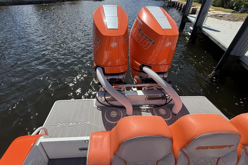Slide: The Image of 2025 Concept 32' CC boat with dual orange Mercury Racing 400 engines on water. - 8