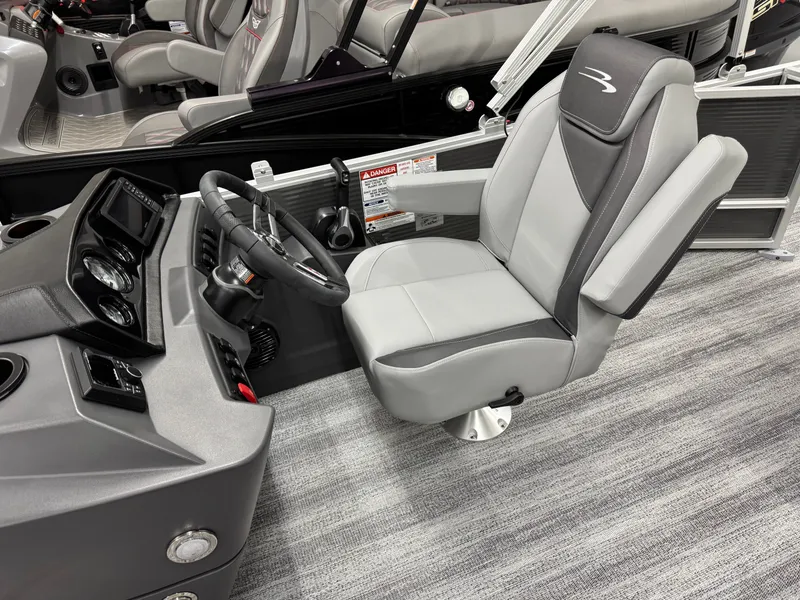 Slide: The Image of Interior of 2026 Bennington 188SL with gray captain's chair and dashboard. - 19