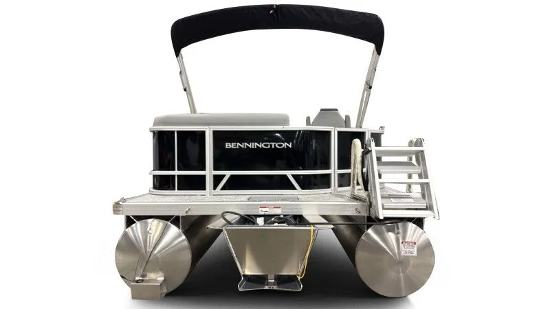 Slide: The Image of 2026 Bennington 20SL pontoon boat, rear view with black canopy and aluminum construction. - 7