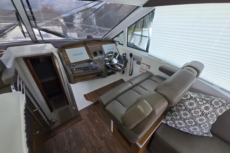 Slide: The Image of 2016 Cruisers Sport Series 45 Cantius yacht with spacious gray seating area. - 12