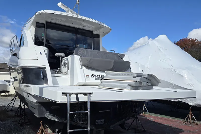 Slide: The Image of 2016 Cruisers Sport Series 45 Cantius yacht on stands under a clear blue sky. - 17