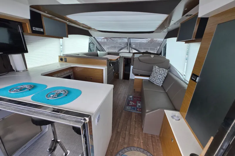 Slide: The Image of Interior view of 2016 Cruisers Sport Series 45 Cantius yacht with modern seating and bar area. - 2