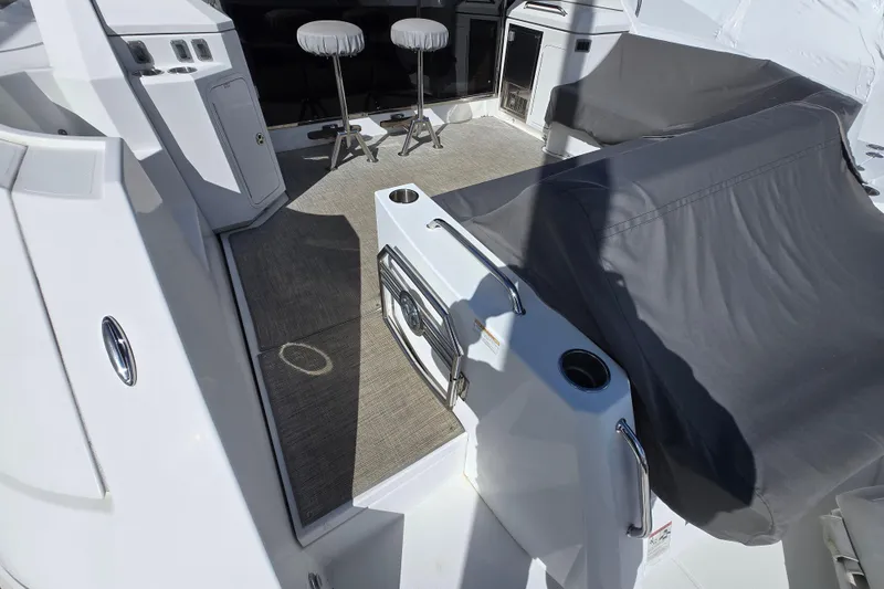 Slide: The Image of 2016 Cruisers Sport Series 45 Cantius yacht deck with seating and outdoor amenities. - 20