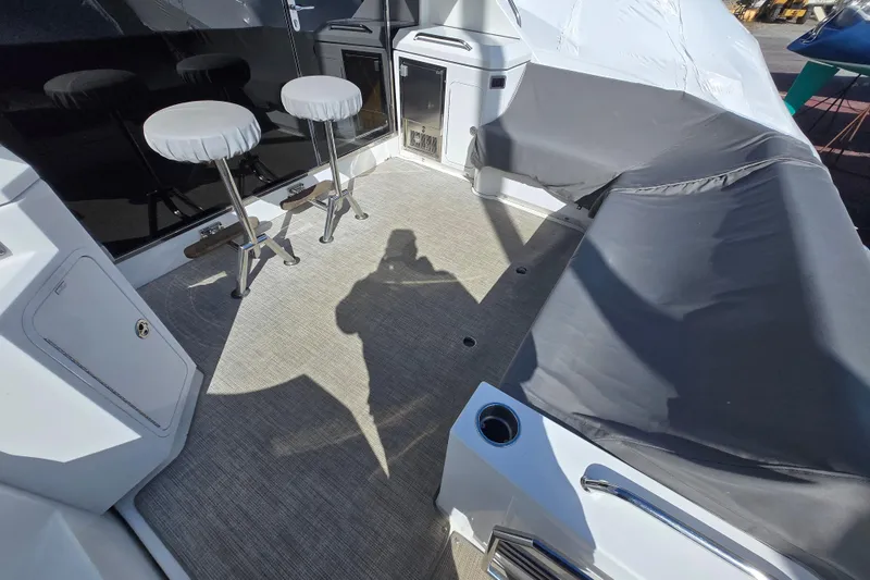Slide: The Image of 2016 Cruisers Sport Series 45 Cantius yacht deck with seating and covered area. - 21