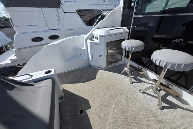 Slide: The Image of 2016 Cruisers Sport Series 45 Cantius yacht deck with seating and covered area. - 22