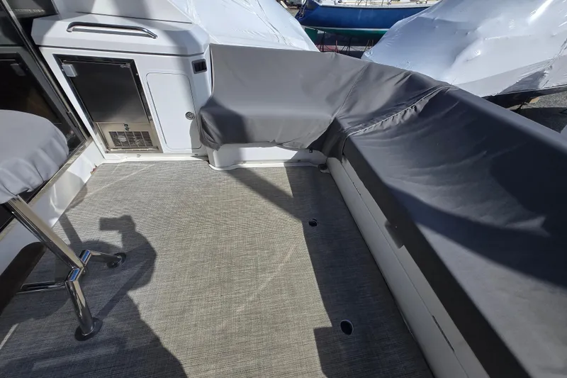 Slide: The Image of 2016 Cruisers Sport Series 45 Cantius yacht deck with seating and covered area. - 23