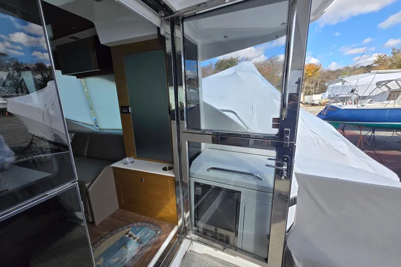 Slide: The Image of 2016 Cruisers Sport Series 45 Cantius yacht deck with seating and covered furniture. - 25