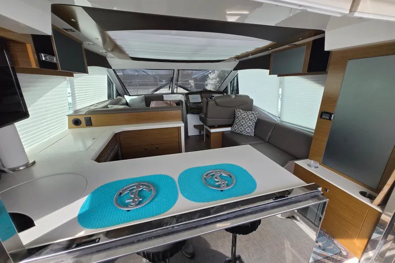 Slide: The Image of Interior of 2016 Cruisers Sport Series 45 Cantius yacht with sleek seating and wood flooring. - 32