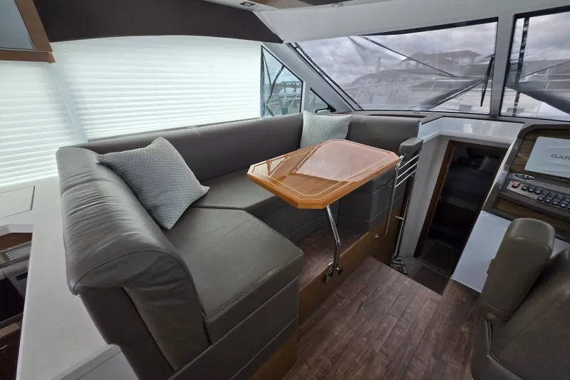 Slide: The Image of 2016 Cruisers Sport Series 45 Cantius yacht docked, featuring covered seating and sleek design. - 9