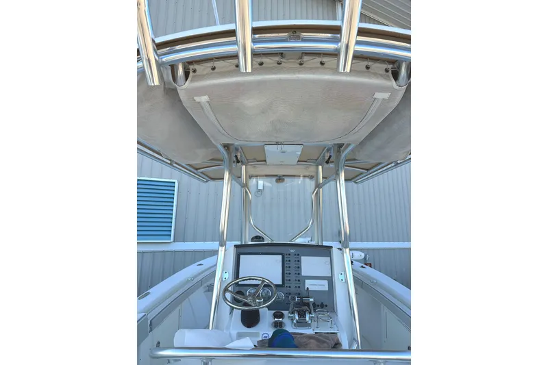 Slide: The Image of 2006 Southport 26 Center Console boat helm with steering wheel and controls. - 14