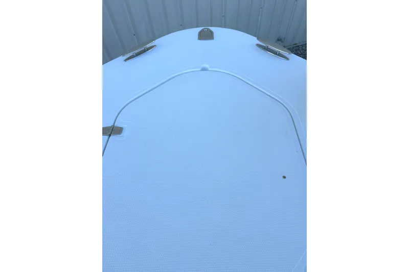 Slide: The Image of Bow of 2006 Southport 26 Center Console boat with cleats and textured surface. - 17