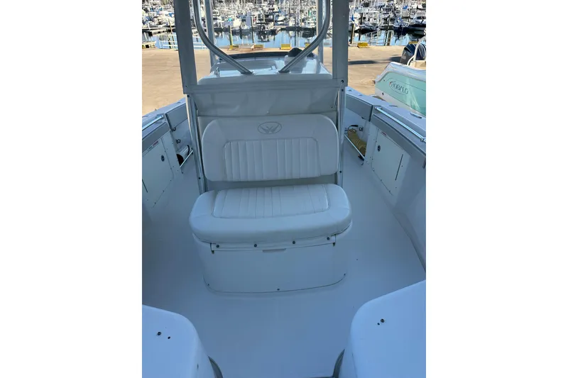 Slide: The Image of 2006 Southport 26 Center Console boat interior with white seating at marina. - 19