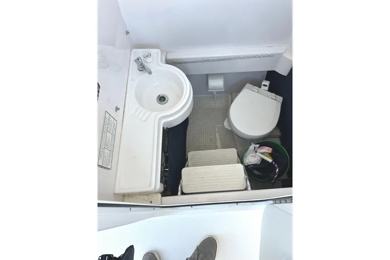 Slide: The Image of Compact bathroom in 2006 Southport 26 Center Console boat with sink and toilet. - 23
