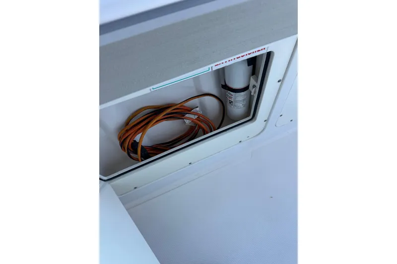 Slide: The Image of Storage compartment in a 2006 Southport 26 Center Console boat with coiled cable. - 24