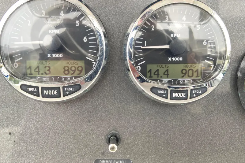 Slide: The Image of Close-up of 2006 Southport 26 Center Console boat gauges displaying RPM, volts, and hours. - 26