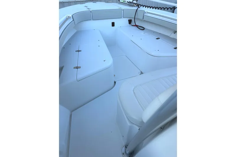 Slide: The Image of 2006 Southport 26 Center Console boat interior with white seating and storage compartments. - 9
