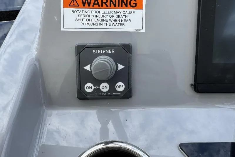 Slide: The Image of Control panel on 2024 Beneteau Flyer 10 boat with warning label and Sleipner thruster. - 14