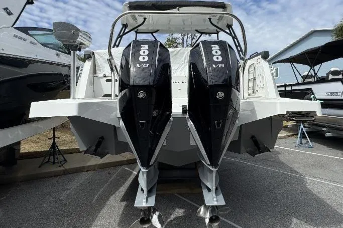 Slide: The Image of 2024 Beneteau Flyer 10 with dual 300 V8 engines, docked outdoors. - 3