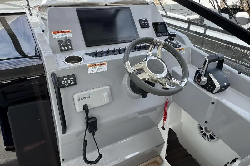 Slide: The Image of 2024 Beneteau Flyer 10 helm with Garmin navigation and modern controls. - 9