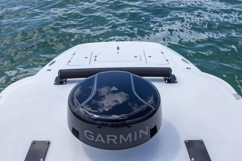 Slide: The Image of 2026 Invincible 36 Catamaran with Garmin equipment on deck, near water. - 12